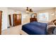 Bright main bedroom featuring neutral carpet, ceiling fan, and large window at 7083 Leopard Dr, Lone Tree, CO 80124