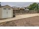 Backyard featuring a storage shed, wood fence with planters, and a concrete area at 380 S 25Th Ave, Brighton, CO 80601