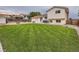 Well-maintained backyard with a lush lawn, patio seating, and a charming fire pit at 380 S 25Th Ave, Brighton, CO 80601