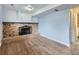 Carpeted basement featuring a brick fireplace and built-in shelving at 380 S 25Th Ave, Brighton, CO 80601