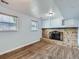 Cozy basement featuring a brick fireplace, plush carpeting, and neutral wall paint at 380 S 25Th Ave, Brighton, CO 80601