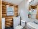 Bathroom and laundry room combo featuring wood paneling at 380 S 25Th Ave, Brighton, CO 80601