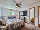 Bedroom with a ceiling fan, large bed, and access to an en-suite bathroom at 380 S 25Th Ave, Brighton, CO 80601