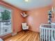 Cozy Bedroom with a rocking chair, crib, and charming hammock for stuffed animals at 380 S 25Th Ave, Brighton, CO 80601