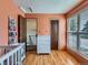 Bright bedroom with wooden floors, white dresser, and access to the upper level at 380 S 25Th Ave, Brighton, CO 80601