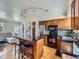 Modern kitchen with stainless steel appliances, a central island with bar stools, and hardwood floors at 380 S 25Th Ave, Brighton, CO 80601