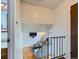Stairway landing leading to an airy living room with wood floors at 380 S 25Th Ave, Brighton, CO 80601