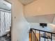 View of stairway leading to living room with black iron railing at 380 S 25Th Ave, Brighton, CO 80601