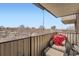 Cozy balcony seating area with a view of the city and neighborhood trees, perfect for relaxation at 1313 Steele St # 606, Denver, CO 80206