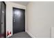 Hallway featuring a unit door with a black door and gray flooring at 1313 Steele St # 606, Denver, CO 80206