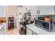 Updated kitchen with white cabinets, tile backsplash, and stainless steel appliances at 1313 Steele St # 606, Denver, CO 80206