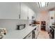 Bright condo kitchen with white cabinets, modern appliances, and lots of counter space at 1313 Steele St # 606, Denver, CO 80206