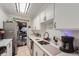 Clean kitchen featuring white cabinets, modern appliances, and tiled floor at 1313 Steele St # 606, Denver, CO 80206