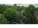 Neighborhood scene shows lush foliage, rooftops, and a glimpse of Denver through mature trees in a serene setting at 1313 Steele St # 606, Denver, CO 80206