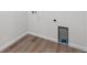 The laundry room features vinyl wood flooring, white walls, and connections for a washer and dryer at 9141 Telluride Ct, Commerce City, CO 80022