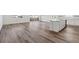 Open-concept living area boasts luxury vinyl flooring and access to a modern kitchen and dining space at 9141 Telluride Ct, Commerce City, CO 80022