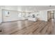 Bright, open-concept kitchen and living area featuring luxury vinyl flooring and neutral walls at 9141 Telluride Ct, Commerce City, CO 80022