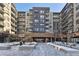 Exterior view of Encore, a modern building with snow-covered landscaping at 20 Wilcox St # 613, Castle Rock, CO 80104