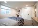 This bedroom features a window, a desk with shelving and a large closet at 7270 S Jay St, Littleton, CO 80128