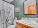 Charming bathroom with a mountain-themed shower curtain, plants, and a classic vanity at 30813 Kings Valley Dr, Conifer, CO 80433