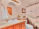 Classic bathroom with a wooden vanity, framed artwork, and a nature-themed shower curtain at 30813 Kings Valley Dr, Conifer, CO 80433