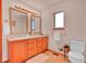 Neutral bathroom with a double vanity, tile floors, and framed mirrors at 30813 Kings Valley Dr, Conifer, CO 80433