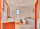 Bright bathroom featuring a double vanity, soaking tub, and tiled flooring at 30813 Kings Valley Dr, Conifer, CO 80433