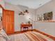 Bright bedroom with a view, a cozy bed, and a desk with plants creating a serene atmosphere at 30813 Kings Valley Dr, Conifer, CO 80433