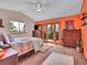 Comfortable bedroom with an accent wall, balcony access, and scenic views from the window at 30813 Kings Valley Dr, Conifer, CO 80433