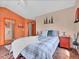 Comfortable bedroom with plaid bedding, area rug, and ensuite bathroom access at 30813 Kings Valley Dr, Conifer, CO 80433