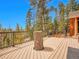 Expansive deck with beautiful mountain views, custom furniture, and cozy seating at 30813 Kings Valley Dr, Conifer, CO 80433