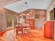 Elegant dining room with wood floors, large windows, and stylish light fixture at 30813 Kings Valley Dr, Conifer, CO 80433