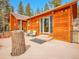 Exterior view of wooden cabin with a large deck and outdoor seating at 30813 Kings Valley Dr, Conifer, CO 80433