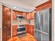 Efficient kitchen layout with stainless steel appliances, wood cabinets, and tile backsplash at 30813 Kings Valley Dr, Conifer, CO 80433