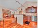 Open-concept kitchen with stainless steel appliances and wood cabinets, flows into dining area at 30813 Kings Valley Dr, Conifer, CO 80433