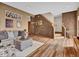 Inviting living room with comfortable seating, textured wall, and stairway leading to the upper level at 30813 Kings Valley Dr, Conifer, CO 80433