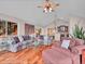 Open-concept living room with hardwood floors, comfortable seating, and a view into the kitchen area at 30813 Kings Valley Dr, Conifer, CO 80433