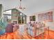 Inviting living room features hardwood floors, vaulted ceilings, a fireplace, and large windows with scenic views at 30813 Kings Valley Dr, Conifer, CO 80433