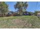 Spacious backyard with a large grassy area and mature trees, perfect for outdoor activities and relaxation at 695 S Quitman St, Denver, CO 80219