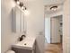 This bathroom has modern fixtures and lighting, complemented by a white vanity at 695 S Quitman St, Denver, CO 80219