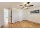 Bright bedroom with hardwood floors, white walls, and a ceiling fan for added comfort at 695 S Quitman St, Denver, CO 80219