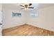 Cozy bedroom with hardwood floors, neutral walls, and ample natural light from two windows at 695 S Quitman St, Denver, CO 80219
