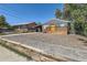 Charming exterior featuring a grey paint, a lovely yellow door, a deck, and low-maintenance yard at 695 S Quitman St, Denver, CO 80219