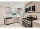 Modern kitchen featuring stainless steel appliances, sleek countertops, and updated fixtures at 695 S Quitman St, Denver, CO 80219
