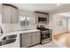 Updated kitchen features stainless steel appliances, modern countertops, and bright white subway tile backsplash at 695 S Quitman St, Denver, CO 80219