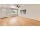 Bright living room featuring gleaming hardwood floors and large windows letting in natural light at 695 S Quitman St, Denver, CO 80219