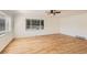 Bright living room featuring gleaming hardwood floors and large windows letting in natural light at 695 S Quitman St, Denver, CO 80219