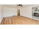 Spacious living area with gleaming hardwood floors leading into an updated kitchen area at 695 S Quitman St, Denver, CO 80219