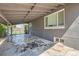 Covered patio area featuring decorative rock floor and backyard access at 695 S Quitman St, Denver, CO 80219