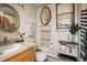 Cozy bathroom featuring decorative mirrors, vessel sink with cabinet, and stylish towel arrangements for a welcoming touch at 801 Confidence Dr # 2, Longmont, CO 80504
